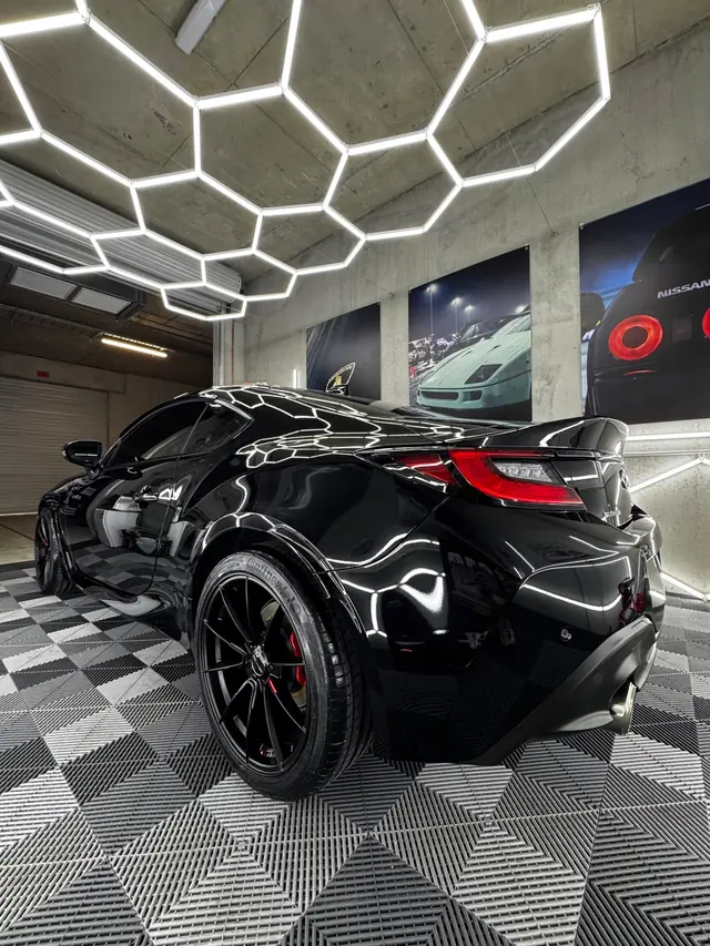 Black Toyota GR86 rear three-quarter with red brake calipers